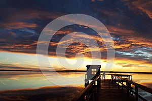 Sunset. The man on the pier. Beautiful clouds. Background