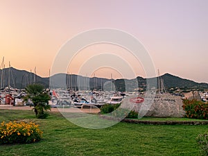 Sunset on the marina of Villasimius. Recreational boats are still in calm water