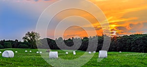 Sunset in Meadow with Hay Bales