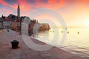 Sunset at medieval town of Rovinj, colorful with houses and church