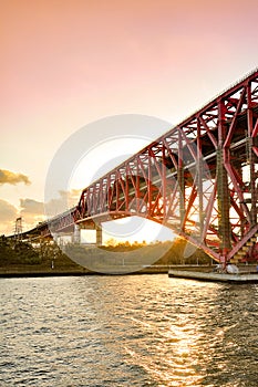 Sunset at the Minato Bridge red bridge in Osaka crossing over