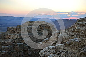 Sunset at Mitzpe Ramon crater, camel rock at Makhtesh Ramon, Negev desert, South Israel