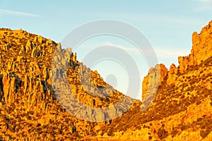 Sunset mountain hills in cliffs of arizona sonora desert in tuscon with hazy whtie and blue sky in evening sunset rocks