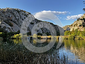 sunset mountain lake with small waterfalls, soft ligh, mirroring like in glass mountain in water. Croatia, Krnjeza in Kanyon, in