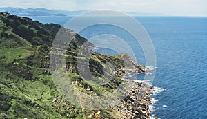 Sunset in mountain natura perspective landscape. Green valley island on background blue sky, clouds, sea ocean. Panorama horizon