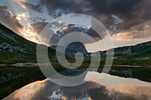 Sunset mountain reflected on natural lake