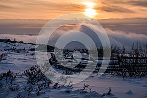 Sunset on the Mountain Through Winter Fog