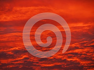 Sunset in the mountains with orange red sky and clouds. Winter Carpathian Mountains Ukraine, Europe. Cloudscape view .