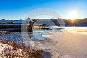 Sunset with mystical atmosphere at the winterly snowy Edersee in Germany