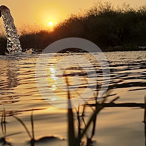 Sunset near a tube well seems like a lake