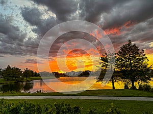 Sunset in a neighborhood that reflects on a Lake