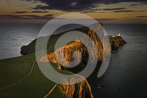 Sunset at Neist Point, famous cliff head with lighthouse on Isle of Skye, Scotland,UK