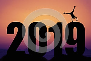 Sunset with New year 2019 silhouette with gymnast as symbol for