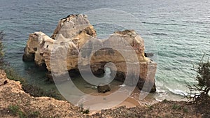 Sunset on the ocean, coast of Portimao, Algarve, Portugal, famous cliffs and caves in rocks, beach, waves, sand, beautiful clouds