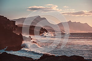 Sunset. ocean landscape. Rocks and wave with fog