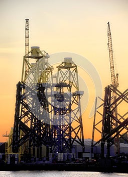 Sunset at an offshore wind turbine base construction site on the River Tyne