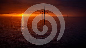 Sunset offshore at wind turbine farm