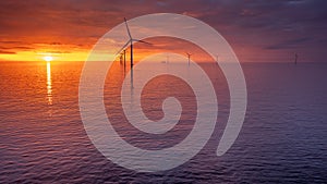 Sunset offshore at wind turbine farm