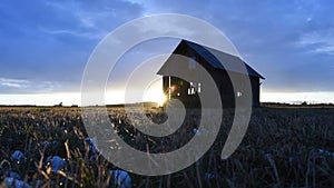 Sunset at an old barn on a farmer\'s field