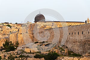 Sunset in the old city of Jerusalem. Al-Aqsa Mosque and historic walls of old city.