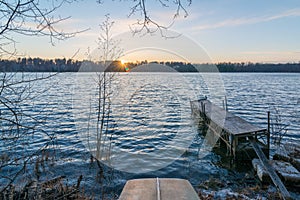 Sunset with old dock and old row boat on small remote lake in Northern Wisconsin