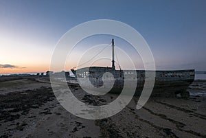 Sunset and old shipwreck in Arz Island in Brittany Morbihan, F photo