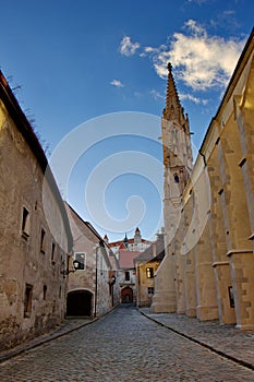 Sunset in old street of Bratislava, castle and church in the evening, Slovakia