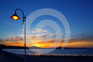 Sunset orange blue seascape light lamppost photo