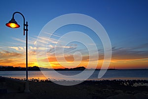 Sunset orange blue seascape light lamppost photo