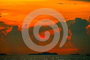 sunset orange cloud back on dark silhouette sky and fishing boat on sea
