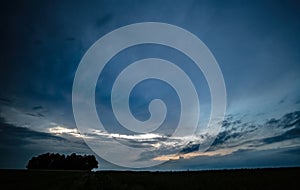 Sunset outside with a cloudy sky before a stormsunset in the field