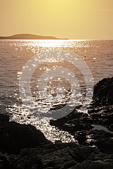 Sunset over Adriatic sea with sun in waves