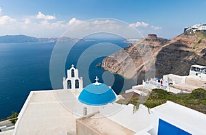 Sunset over aegean sea with view to Virgin Mary Catholic Church Three Bells of Fira, Santorini.