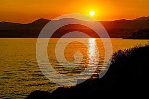 Sunset over Alpes on Azure Coast French Riviera of Mediterranean Sea seen from Saint-Jean-Cap-Ferrat town in France