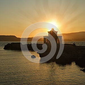 Sunset over Argostoli Lighthouse on Cephalonia photo