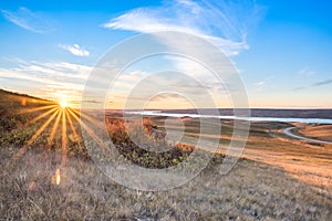 Sunset over autumn leaves on a hillside overlooking Lake Diefenbaker