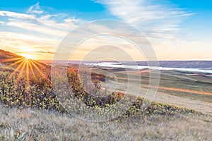 Sunset over autumn leaves on a hillside overlooking Lake Diefenbaker