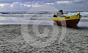 Sunset over Baltic Sea with fishing boat on the beach - Debki, Poland
