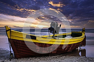 Sunset over Baltic Sea with fishing boat on the beach - Debki, Poland