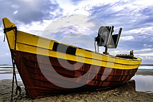 Sunset over Baltic Sea with fishing boat on the beach - Debki, Poland