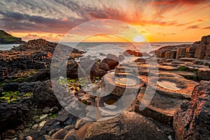 sunset over basalt columns Giant's Causeway, County Antrim, Northern Ireland photo