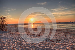 Sunset over the beach as a waterway of Clam Pass