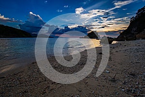 Sunset over a beach close to the coral garden on San Antonio island, Puerto Galera, Oriental Mindoro region in the Philippines photo