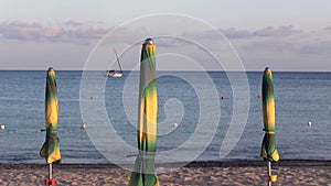 Sunset over the beach. Sailing, beach umbrellas.