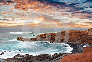 sunset over the beautiful landscape of the coast Los Hervideros in the canary islands