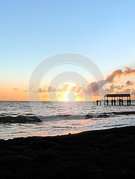 Sunset over blacksand beach near Waimea