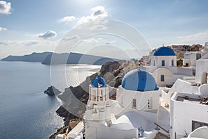 Sunset over blue domed churches on the Caldera at Oia on the Greek Island of Santorini.