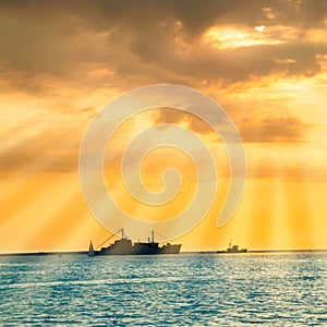 Sunset over blue sea with ship