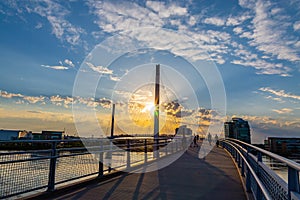 Sunset over Bob Kerrey Pedestrian bridge and swollen Missouri River at Omaha Riverfront