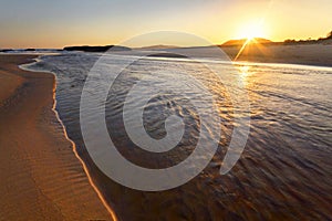 a sunset over a body of water in South West Rocks in Australia